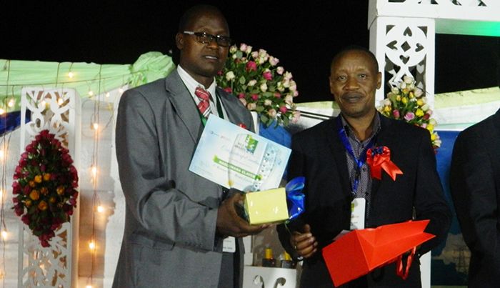 NBD Board Chair (Right) hands over the award to Mr. Hakizimana, the first runner-up in the Radio category