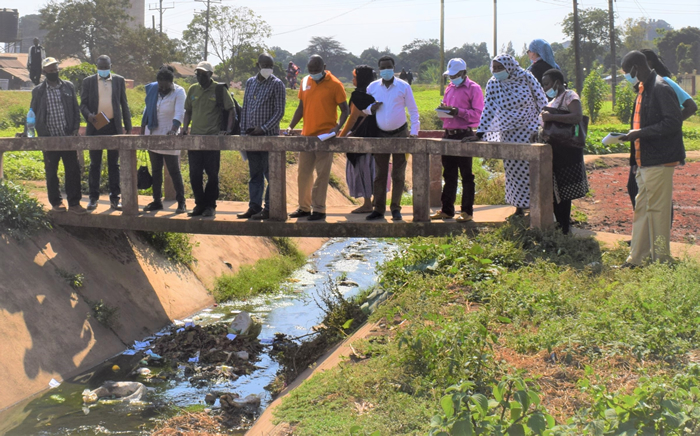 During a field study visit; Participants observe deposits of domestic waste in one of the tributaries that feed river IIboru - Sinoni from the outskirt communities of Arusha city